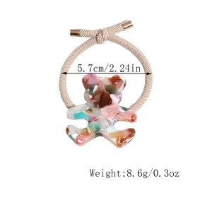 Detail showing elastic hair tie with marble-patterned resin bear pendant and gold cap