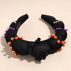 Detail of black padded satin headband with Halloween faux pearls and non-slip lining