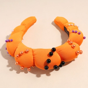 Top view of orange padded headband with colorful faux pearl accents and soft knit texture