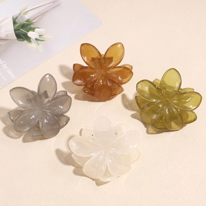Set of four elegant floral hair claws in jelly colors like amber, green, and cream