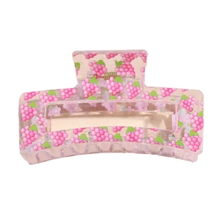 Pink translucent rectangular hair claw clip with vibrant grape pattern and metal spring