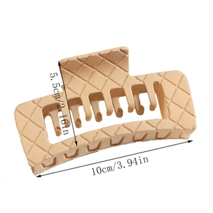 Detail view of a 10cm beige matte hair claw clip featuring classic quilted lattice texture