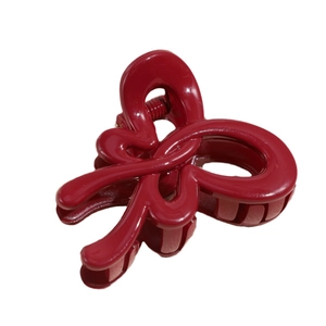 Elegant wine red twisted bow hair claw clip with glossy finish for women's hairstyle
