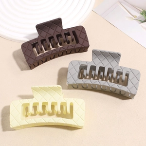 Three-piece set of large matte square hair claws with textured diamond pattern in neutral tones
