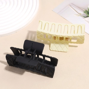 Set of two matte quilted hair claws in black and cream yellow for elegant styling