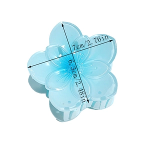 Detail view of light blue flower hair claw clip with size measurements 7cm x 6.3cm