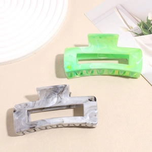 Large square acetate hair claws in marble grey and bright green with non-slip hollow design
