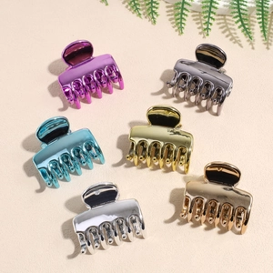 Lot de 6 pinces à cheveux nuage métalliques colorées sur un fond à texture de sable
