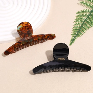 French vintage acetate hair claws in tortoiseshell and black with golden lettering