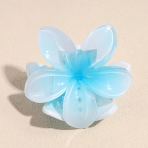 Detail view of sky blue and white gradient flower hair claw clip with serrated teeth