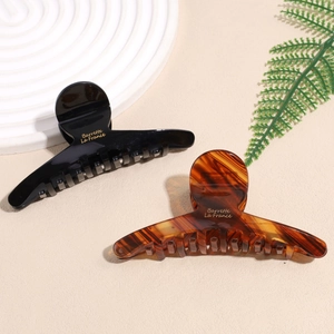 Set of minimalist black and amber cellulose acetate hair claws with gold Barrette lettering