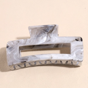 Detailed macro view of rectangular marble texture hair claw clip with nonslip teeth