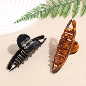 Classic tortoiseshell and black acetate hair claws with gold Barrette La France lettering