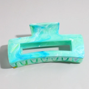 Detail view of large marble texture non-slip hair claw clip with hollow square design