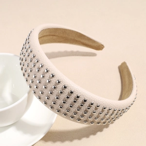 Close-up of beige lychee texture faux leather headband with silver rivet stud details