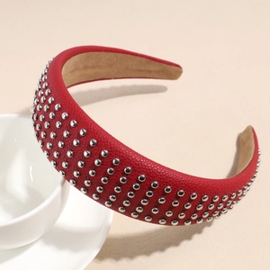 Detail of red pebbled leather headband with silver rivet studs and non-slip inner lining