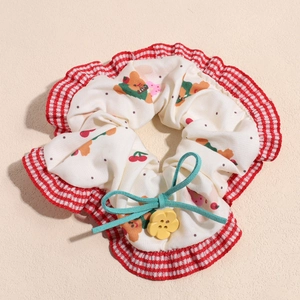 Detail of white scrunchie with bear cherry prints and mint green bow with yellow flower button
