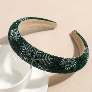 Detail of dark green sponge headband with silver rhinestone snowflakes and velvet lining