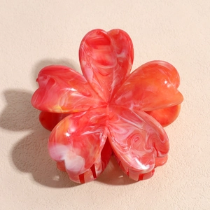 Macro shot of gradient red and white marble texture five-petal flower hair claw clip
