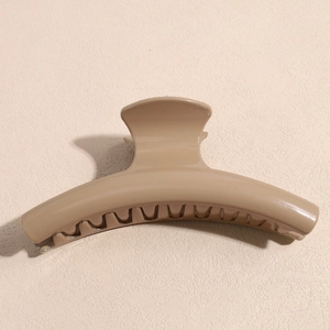 Detailed view of khaki Maillard style shark hair clip with polished finish and strong teeth