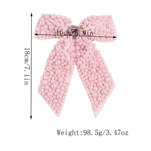 Detail showing dimensions of pink pearl bow hair clip with rhinestone heart accent