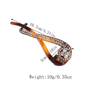 Vue macro montrant dimensions et poids du pince banane ambre torsadé avec strass