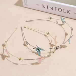 Three-piece metal headband set with enamel butterfly and floral charms in a 45-degree view