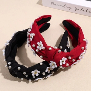 Elegant knotted headbands with pearl and flower accents in black and deep red colors