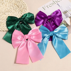 Set of four large satin bow hair clips in green, purple, pink and blue with long ribbons