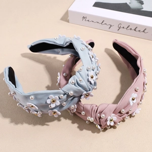 Elegant knotted headband with floral fabric and pearls for a high skull top hairstyle look