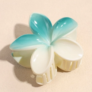 Detail view of the gradient cyan and cream flower hair claw with secure resin teeth