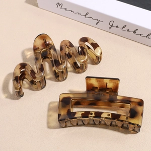Matte amber tortoiseshell large square hair claw clip set with wave design on beige book