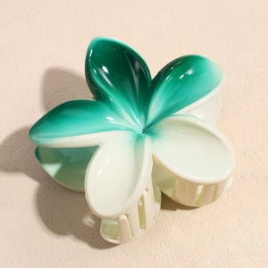 Close-up of a flower hair claw clip with green to cream gradient and glossy finish