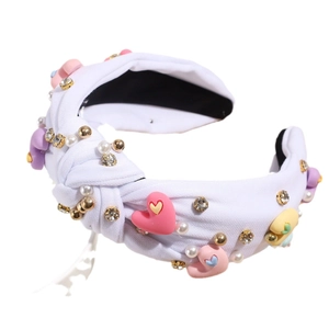Baroque white knot headband with colorful resin hearts and shimmering faux pearls