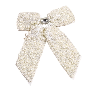 Elegant white ribbon bow hair clip with faux pearls and a large center rhinestone