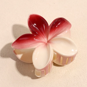 Close-up detail of a 3D gradient flower hair claw clip with a glossy resin finish