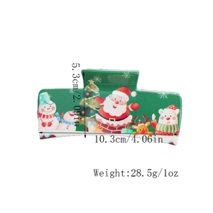 Detailed view of green Christmas hair claw clip with size dimensions and festive print
