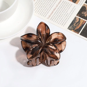 Close-up of translucent amber resin flower hair claw clip with floral petals detail
