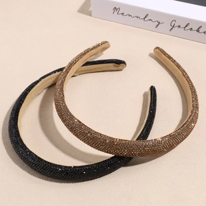 Sparkly rhinestone padded headband set in deep black and champagne gold colors