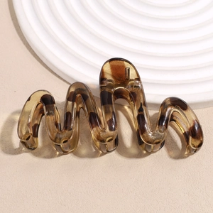 Detail of wavy amber tortoiseshell hair claw clip made of premium smooth acrylic