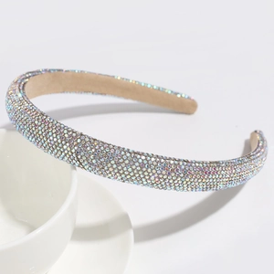 Close-up of sparkling colorful AB rhinestones on a padded headband with light inner lining