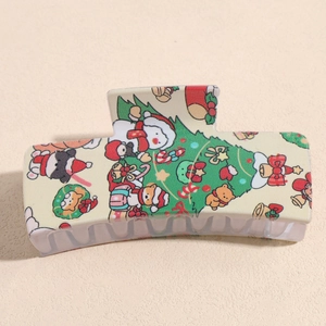 Detail of Christmas claw clip with festive prints of Santa and trees on beige base