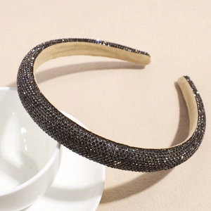 Macro detail of padded wide headband with luxury black rhinestones and soft inner fabric