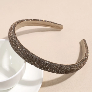 Close-up of sparkling coffee brown rhinestones on a thick padded sponge headband