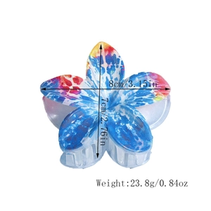 Detailed view of lily flower hair claw with dimensions 8cm x 7cm and watercolor texture