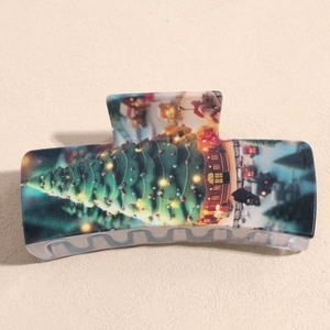Detailed view of square Christmas hair claw clip with festive tree and snow house pattern