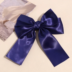 Detailed view of the smooth dark blue satin ribbon hair clip with double bow design