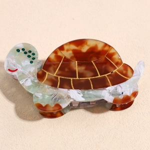 Detail view of turtle hair claw clip with acetate tortoiseshell shell and green marble body