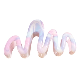Large wavy gradient hair claw clip in pastel marble colors for a stylish hair accessory