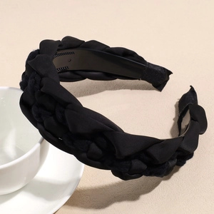 Detail of black braided headband featuring a twist texture and non-slip inner teeth design
